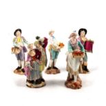 Four Meissen style figures, and a Derby group,