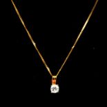 A diamond solitaire pendant and chain.