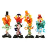 Four colourful Murano glass clowns.