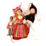 Two dolls and an Austrian pull-chord soldier doll.