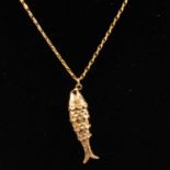 A 9 carat gold articulated fish pendant and chain.