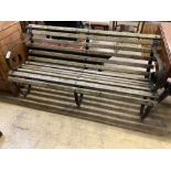 A wrought iron slatted wood garden bench, width 150cm, depth 66cm, height 71cm