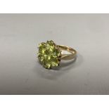 A modern 9ct gold and seven stone peridot cluster ring, size P, gross 3.4 grams.CONDITION: The