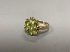 A modern 9ct gold and seven stone peridot cluster ring, size P, gross 3.4 grams.CONDITION: The