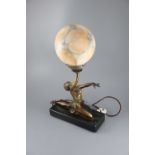 A French Art Deco bronzed spelter table lamp, modelled as a kneeling dancer holding aloft a