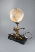 A French Art Deco bronzed spelter table lamp, modelled as a kneeling dancer holding aloft a