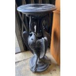 A Victorian ebonised carved wood lamp table in the form of three monopodiae stylised birds, 38cm