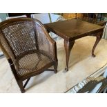 A child's caned mahogany bergere on table stand