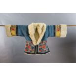 A Chinese embroidered silk winter jacket, late 19th/early 20th century, with white fur lining,