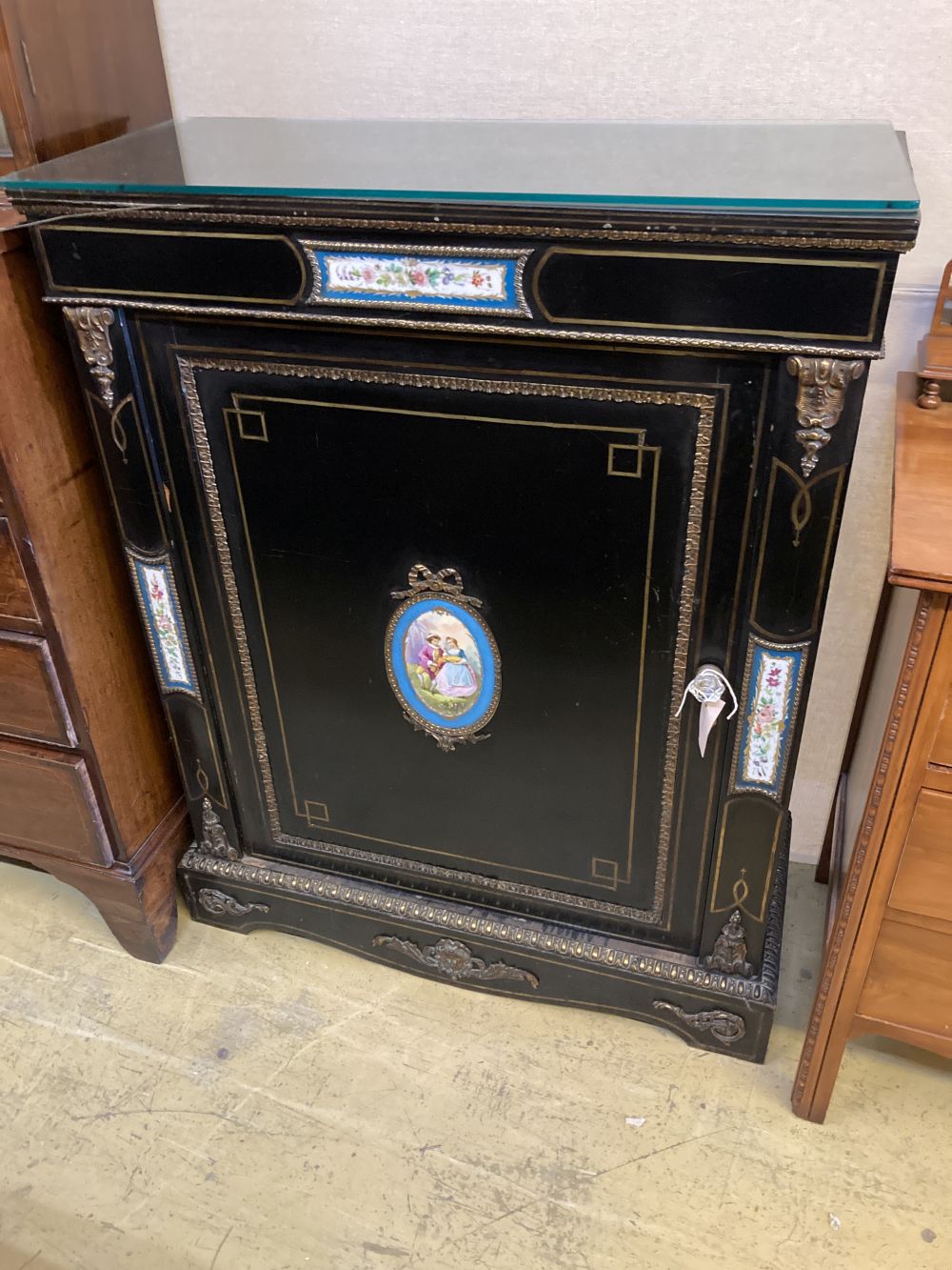 A late Victorian gilt metal and porcelain mounted ebonised pier cabinet, width 84cm, depth 38cm,