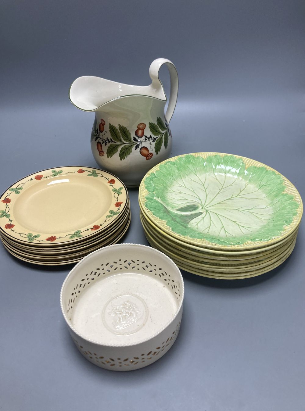 A group of Wedgwood Queensware, 19th century, including ten strawberry plates, a coaster, a jug