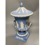 A 20th century Wedgwood light blue jasperware two-handled campagna-shaped urn and cover, decorated