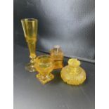 Four items of cut amber glass, 19th / 20th century, comprising two scent bottles, a salt and a