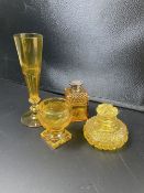 Four items of cut amber glass, 19th / 20th century, comprising two scent bottles, a salt and a