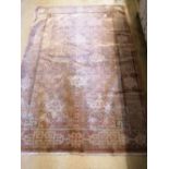 A Chinese rust ground rug, woven with a trellis pattern of scrolling foliage, 120 x 180cm