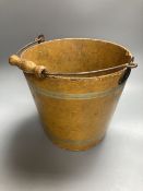 A 19th century papier mache pail, painted in ochre, 26cm excluding swing handle