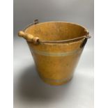 A 19th century papier mache pail, painted in ochre, 26cm excluding swing handle