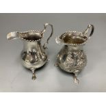 Two 18th century silver cream jugs, London, 1759 & 1768, the former with later embossed