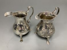 Two 18th century silver cream jugs, London, 1759 & 1768, the former with later embossed