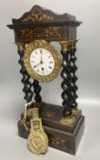 A 19th century French portico ebonised mantel clock, enamelled dial and timepiece movement, gridiron