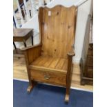 A pitch pine rocking armchair, width 66cm, height 111cm