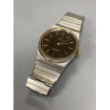 A gentleman's stainless steel and yellow metal Omega Constellation quartz wrist watch, with black