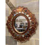 An Indian oval painted wall mirror, width 63cm, height 69cm