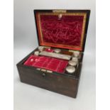 A Victorian rosewood dressing case, with mother of pearl entablature and plate-mounted glass