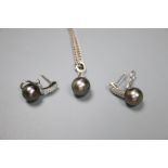 A modern 18k white metal, cultured Tahitian? pearl and diamond set pendant, 27mm and pair of