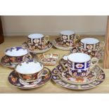 A collection of six Royal Crown Derby cups and saucers, a small square trinket dish and a