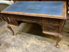 A Queen Anne Revival walnut kneehole desk, width 122cm, depth 62cm, height 75cm