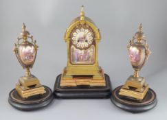 A 19th century French ormolu and enamelled porcelain clock garniture, the eight day clock with