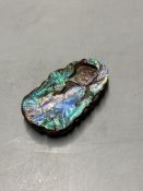 A Chinese carved Australian boulder opal pendant with flowers to the front and fruit to the back,