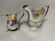 A late Victorian small silver cream jug, Birmingham, 1898, 57mm and a similar silver cream jug,