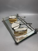 An Art Deco mirrored glass dressing table tray, 40 x 24cm and three Art Deco chrome plated
