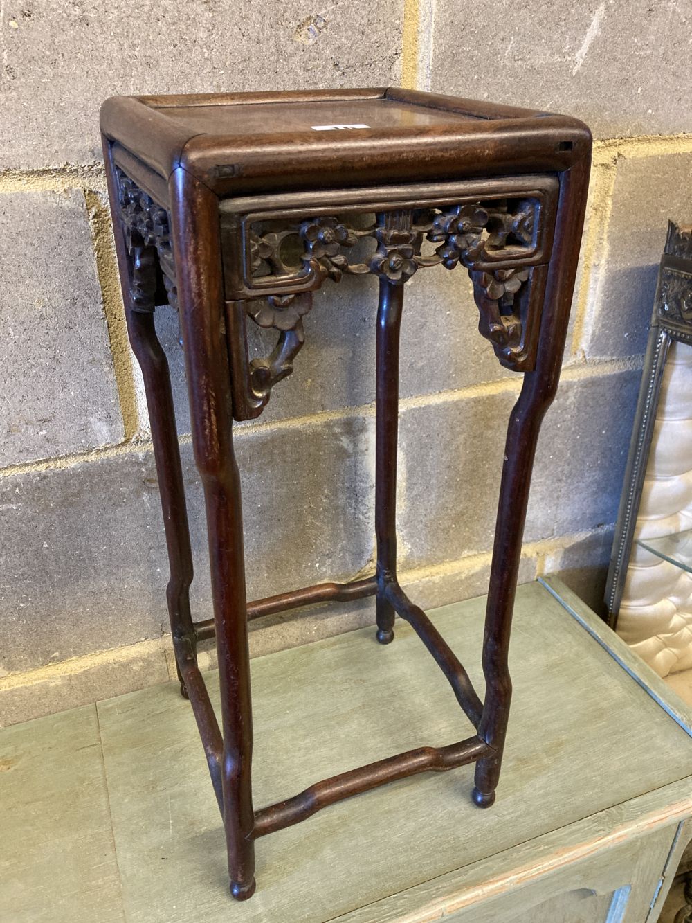 A Chinese carved hardwood square topped stand, width 23cm, height 56cm