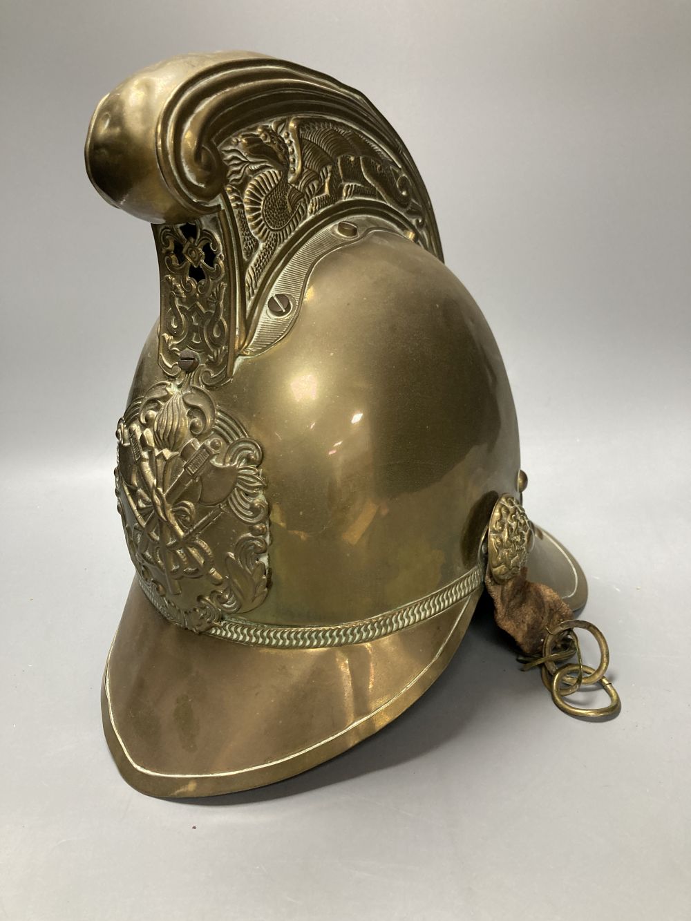 An early 20th century brass fireman's helmet, 17cm