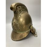 An early 20th century brass fireman's helmet, 17cm