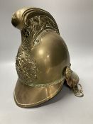 An early 20th century brass fireman's helmet, 17cm