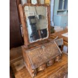 An early 18th century walnut toilet mirror, the base enclosed by fall front over drawer, width 46cm,