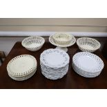 A collection of white glazed basket weave and other dessert ware