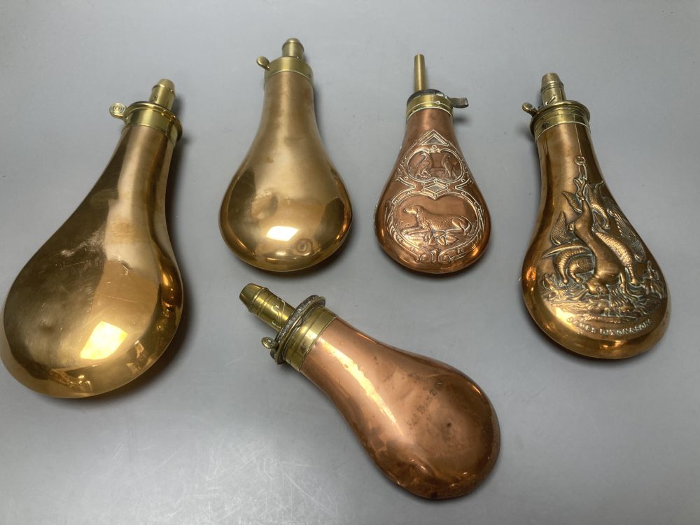 Five Victorian copper powder flasks, with brass mounts, largest 23cm