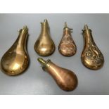 Five Victorian copper powder flasks, with brass mounts, largest 23cm