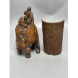 A Chinese bamboo group of figures on an ox and a wrist rest, 23 and 17cm