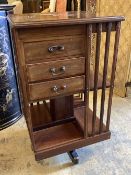 An Edwardian satinwood banded mahogany revolving bookcase, fitted drawers, width 48cm, depth 48cm,