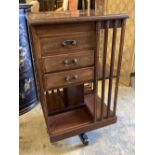 An Edwardian satinwood banded mahogany revolving bookcase, fitted drawers, width 48cm, depth 48cm,