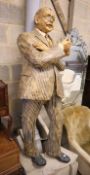 A stuffed papier mache figure of a gentleman holding the Sunday Times, height 170cm