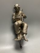 A Victorian silver plated model of a seated tin miner