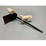 A Japanese ivory group of two carved doves, resting on a hardwood perch, length 21cm