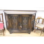 A medieval style carved oak side cabinet, width 120cm, depth 38cm, height 81cm